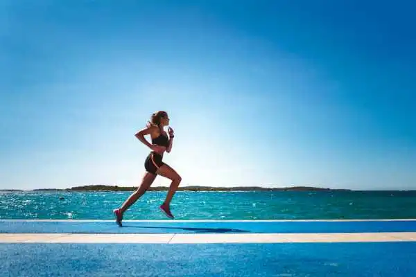 Woman running showing strong leg muscle Worksop